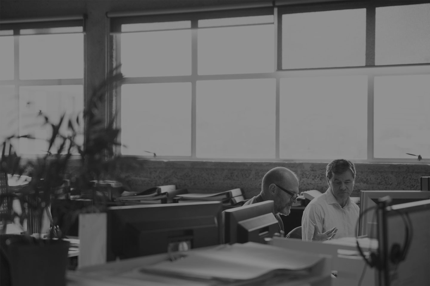 A bright office with two people working